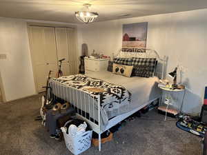 Bedroom featuring carpet, a closet, and an inviting chandelier