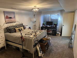 Bedroom with a chandelier and carpet flooring