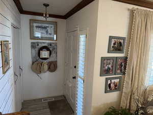 Entrance foyer with engineered hard wood and crown molding