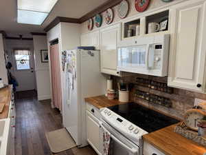 Kitchen featuring wooden counters, white appliances, ornamental molding, white cabinets, and engineered hard wood