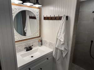 Bathroom featuring toilet, vanity, and shower right off the bedroom, could be a master suite.