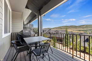 Wooden deck featuring grilling area and a mountain view