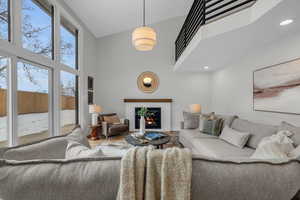 Living room featuring hardwood / wood-style floors, expansive windows, and a brick fireplace