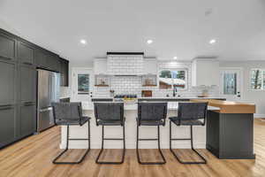 Open kitchen with extra large island, vaulted ceiling and modern finishes