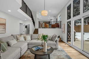 Living room featuring hardwood / wood-style floors, expansive windows, and vaulted ceiling