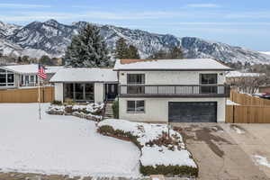 Tri-level home with a garage and a mountain view