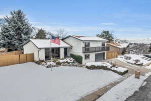 View of front of house with a garage and a mountain view