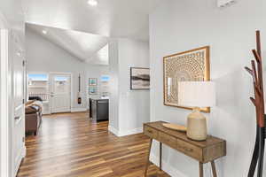 Entrance foyer featuring lofted ceiling and dark wood-type flooring