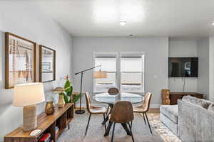 Carpeted dining room featuring a textured ceiling