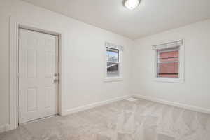 Spare room with light colored carpet