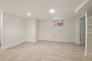 Basement with light colored carpet