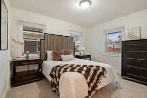 Carpeted bedroom featuring a textured ceiling