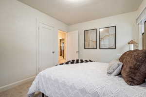 Carpeted bedroom with a textured ceiling