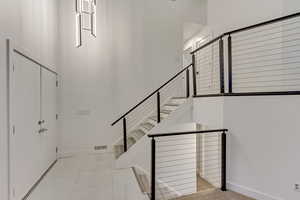 Stairs featuring tile patterned floors