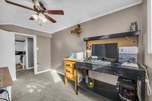 Office area featuring ceiling fan, vaulted ceiling, and crown molding