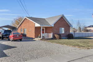 View of front of home featuring a carport and a front yard