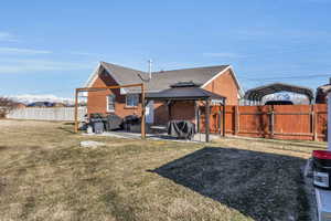 Back of property featuring a gazebo, a yard, and a patio