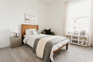 Bedroom with light colored carpet