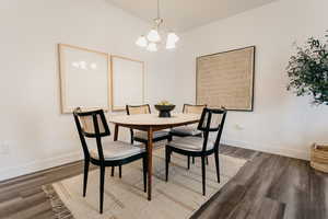 Dining area with a chandelier and hardwood / wood-style flooring