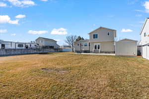 View of yard featuring a trampoline, a storage shed, and a patio