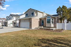 View of front of property with a front yard and a garage