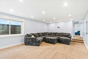 Living room featuring light carpet