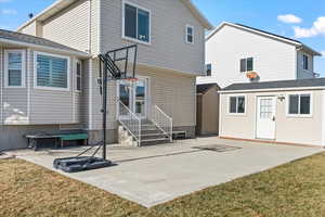 Back of property with an outbuilding, an outdoor fire pit, a yard, and a patio