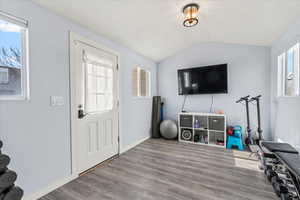 Interior space featuring hardwood / wood-style flooring and lofted ceiling