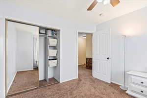 Unfurnished bedroom with ceiling fan, a closet, and carpet flooring