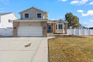 View of front of home featuring a garage and a front lawn