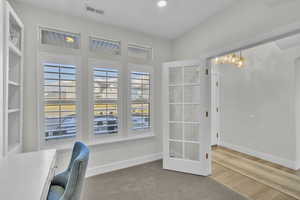 Office featuring light wood-type flooring and built in desk