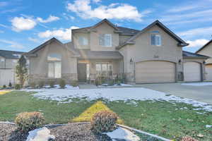 View of front facade featuring a front lawn and a garage