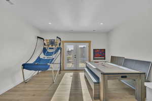 Interior space with french doors and light hardwood / wood-style floors