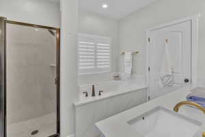 Bathroom featuring independent shower and bath and vanity