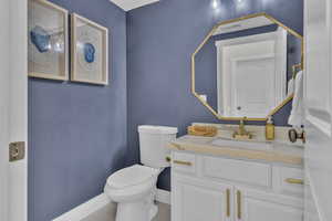 Bathroom featuring tile patterned floors, vanity, and toilet