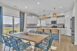 Dining room with light hardwood / wood-style flooring and sink