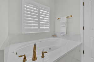 Bathroom featuring a wealth of natural light and a bath