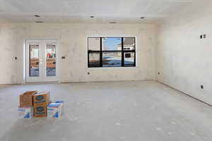 Unfurnished room featuring french doors and plenty of natural light