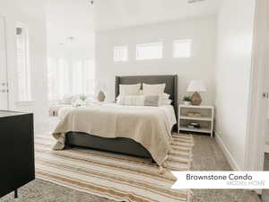 Carpeted bedroom featuring multiple windows