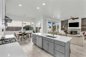 Kitchen with sink, stainless steel dishwasher, a center island, and plenty of natural light