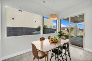 Tiled dining area with a chandelier