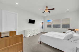 Carpeted bedroom with ceiling fan and access to exterior