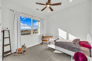 Carpeted bedroom with ceiling fan