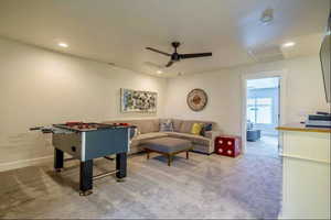 Game room with ceiling fan and carpet flooring