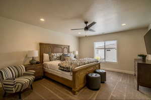 Bedroom featuring ceiling fan and carpet