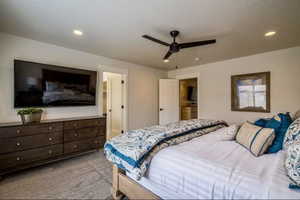 Bedroom with light carpet and ceiling fan