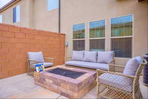 View of patio with an outdoor living space with a fire pit