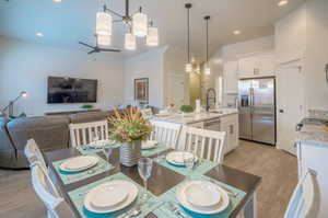 Dining space featuring light hardwood / wood-style floors, sink, and ceiling fan