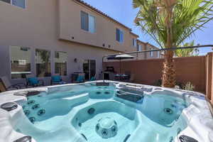 View of swimming pool featuring a hot tub