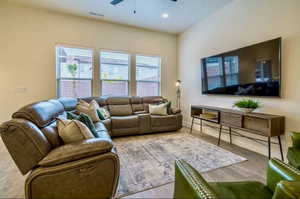 Living room with ceiling fan and hardwood / wood-style floors